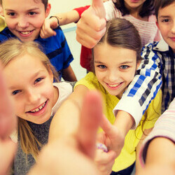 Group of children giving a thumbs up