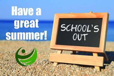 'School's out' written on a blackboard sitting on a beach
