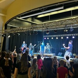 Band performing in school gymnasium